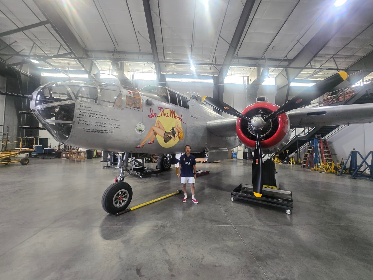Mike Ye standing beside an aircraft at the National Museum of World War II Aviation in Colorado Springs