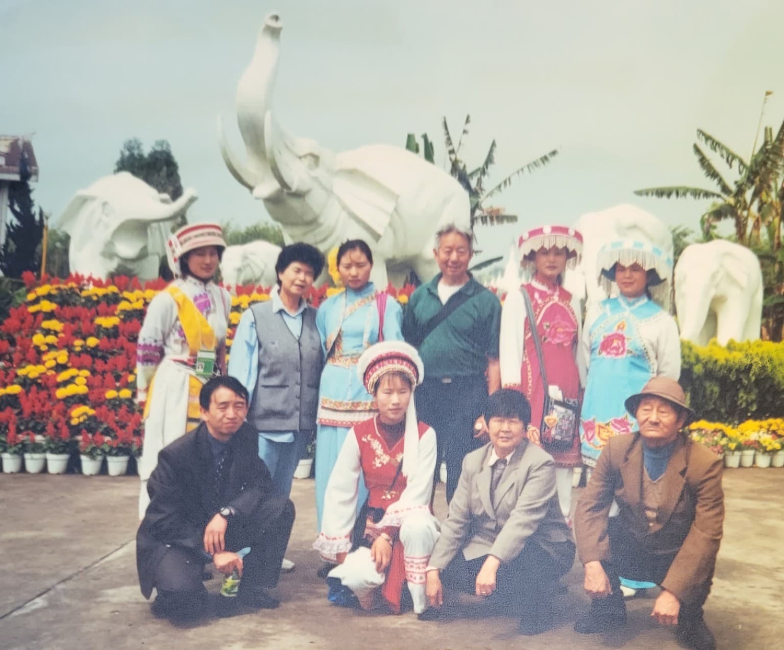 Ye Guozhi and his wife on a return visit to Kunming with people in traditional dress from one of Yunnan’s ethnic minority communities and family members, including Mike’s fourth aunt—his mother’s sister—and Mike’s cousins in front
